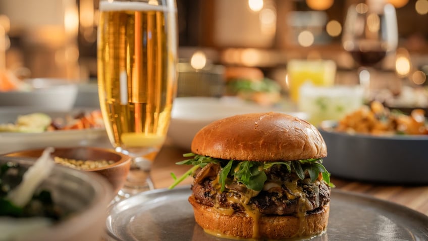 A burger and beer are displayed at True Food Kitchen.