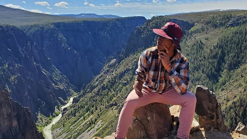 David Robinson sitting on rock