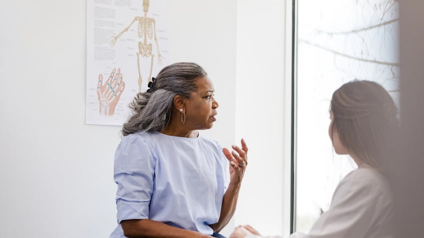 Older woman with doctor