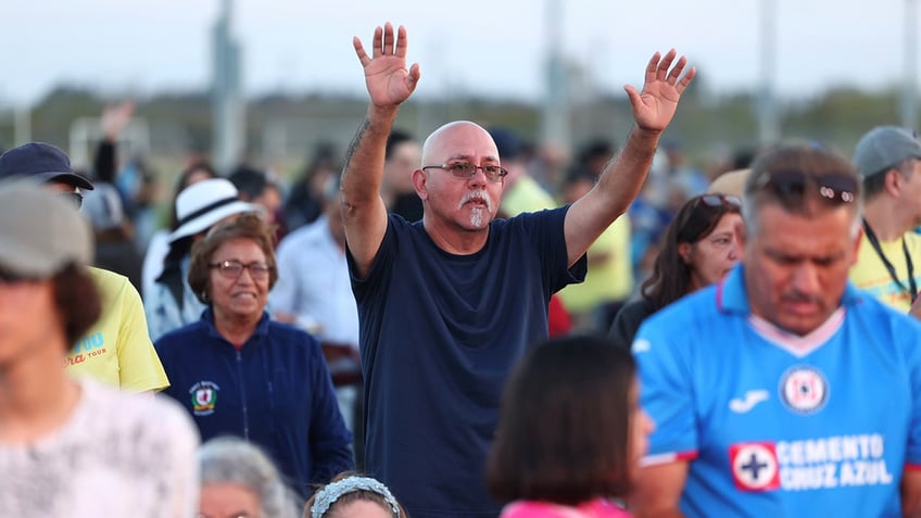 Man worshipping at tour stop