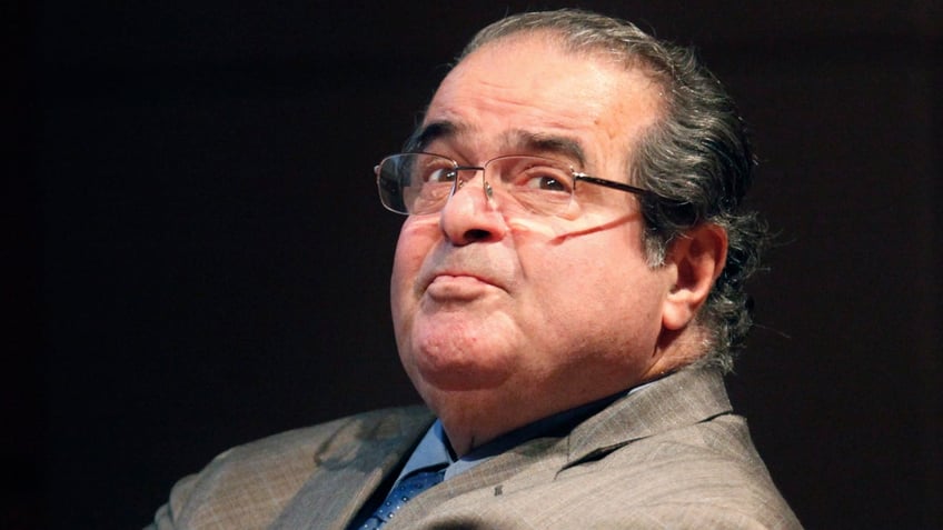 FILE - In this Oct. 18, 2011 file photo, U.S. Supreme Court justice Antonin Scalia looks into the balcony before addressing the Chicago-Kent College Law justice in Chicago. On Saturday, Feb. 13, 2016, the U.S. Marshals Service confirmed that Scalia has died at the age of 79. (AP Photo/Charles Rex Arbogast, File)