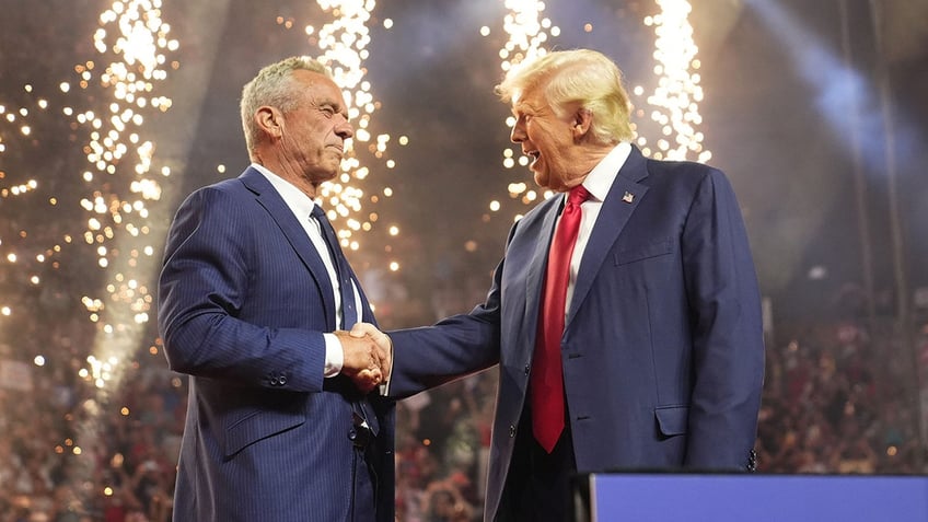 Robert F. Kennedy Jr. shakes hands with Donald Trump