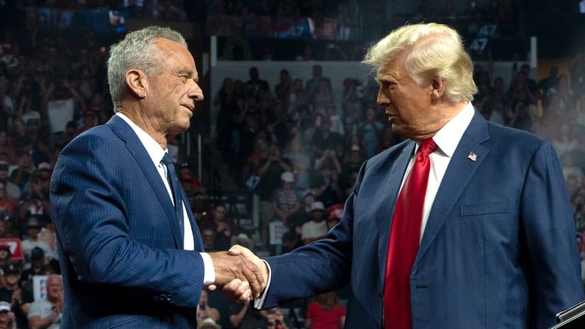 Robert F. Kennedy Jr. shakes hands with Donald Trump