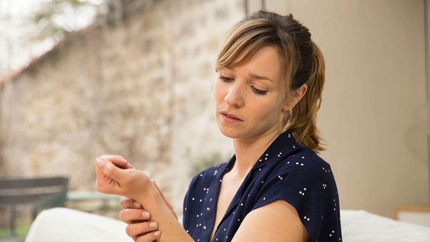 Woman holding her wrist