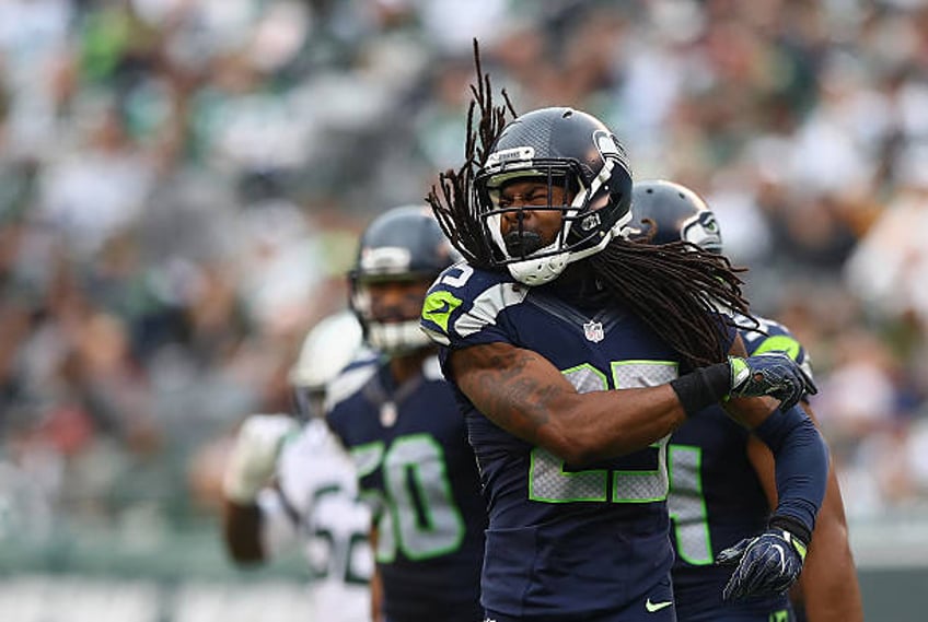 Richard Sherman of the Seattle Seahawks celebrates an interception in the third quarter against the New York Jets at MetLife Stadium on October 2,...