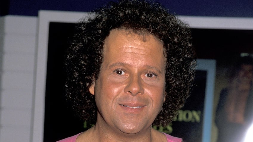 Richard Simmons wears pink tank top.