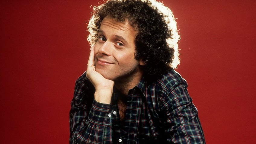 Richard Simmons smiling in plaid shirt