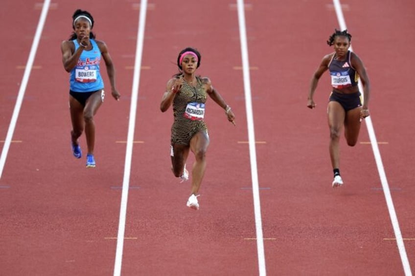 Sha'Carri Richardson (center) coasts to victory in the opening heat of the women's 100m at