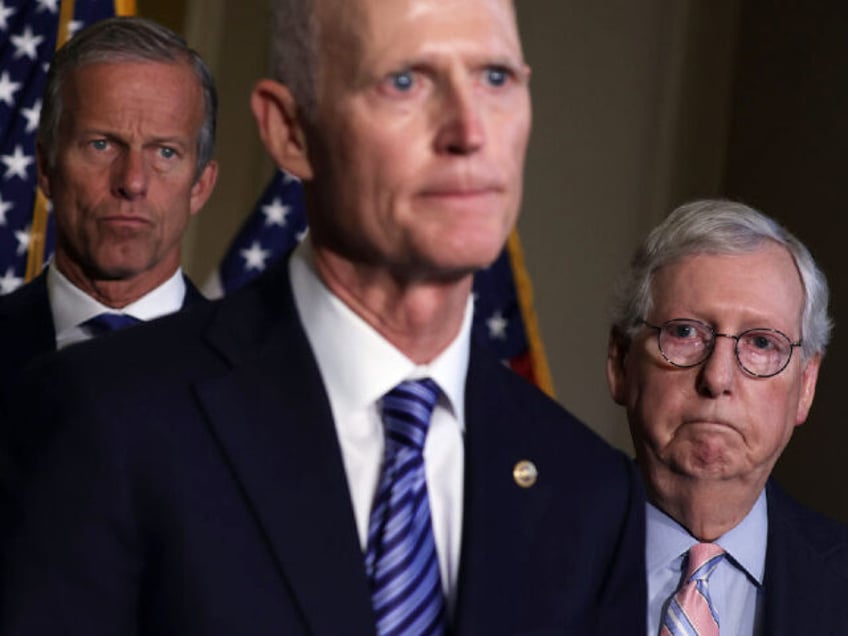 WASHINGTON, DC - SEPTEMBER 13: U.S. Sen. Rick Scott (R-FL) (C) speaks to members of the pr