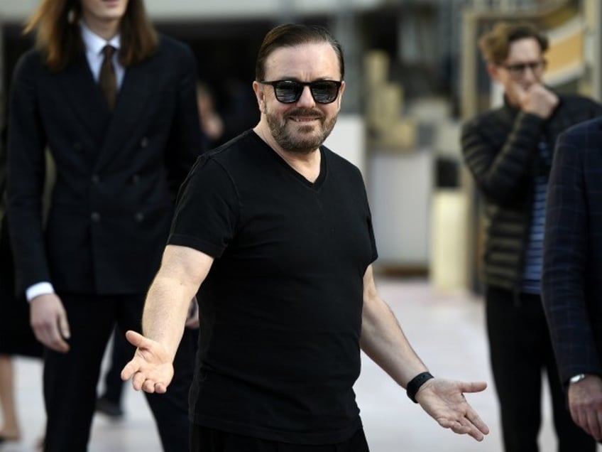 Ricky Gervais, host of the 77th Annual Golden Globe Awards, reacts to photographers during