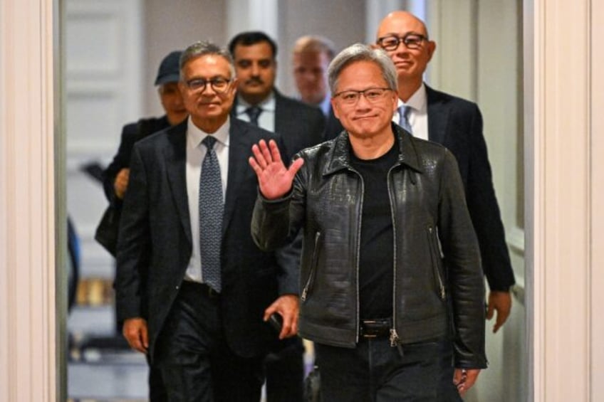 Jensen Huang, cofounder and CEO of Nvidia, waves as he arrives for a media roundtable in K