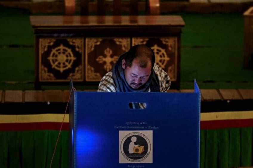 A voter casts his ballot at a polling station during Bhutan's general elections in January