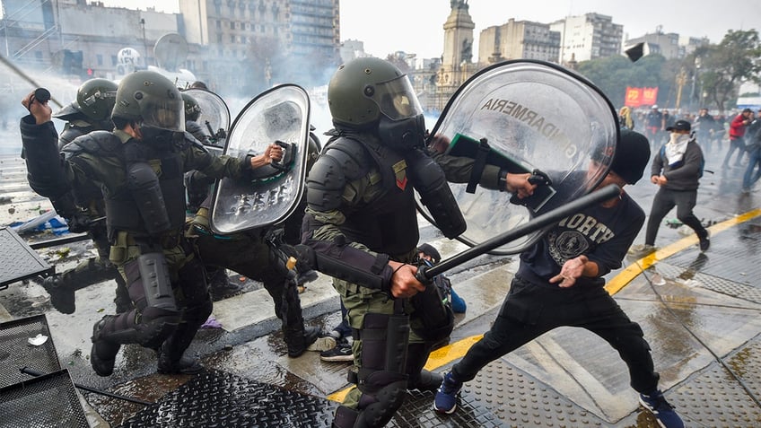 Anti-government protesters clash with police outside Congress, as lawmakers debate a reform bill promoted by Argentine President Javier Milei in Buenos Aires, Argentina, Wednesday, June 12, 2024.