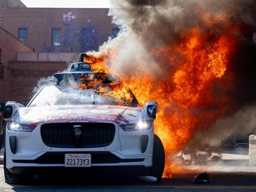 A burning Waymo car in Los Angeles