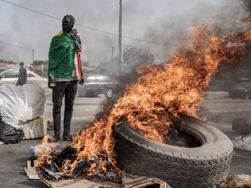 riots in senegal as government postpones presidential election