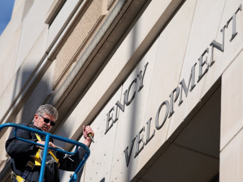 WASHINGTON, DC - FEBRUARY 07: A worker removes the U.S. Agency for International Developme