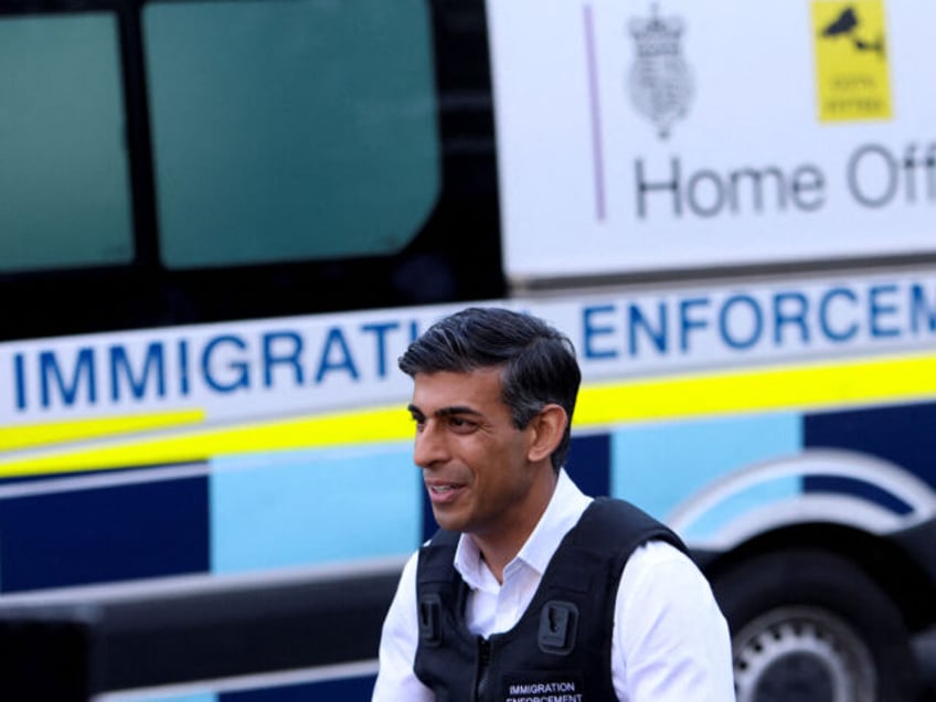 Britain's Prime Minister Rishi Sunak speaks to the press alongside an immigration van at Wembley Police Station in northwest London on June 15, 2023. (Photo by SUSANNAH IRELAND / POOL / AFP) (Photo by SUSANNAH IRELAND/POOL/AFP via Getty Images)