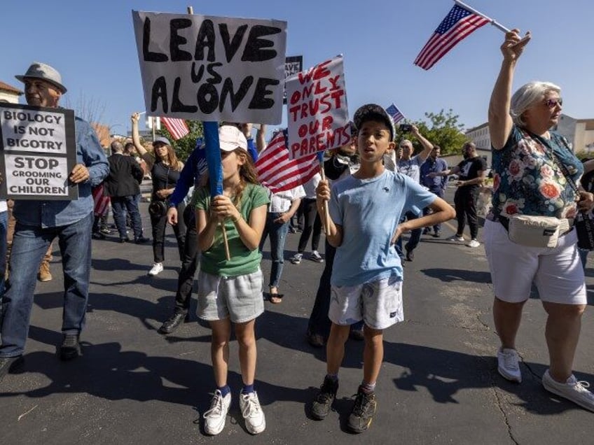 Children among anti-LGBTQ+ demonstrators hold signs outside a Glendale Unified School District (GUSD) Board of Education meeting on June 20, 2023 in Glendale, California. Coming two weeks after another GUSD board meeting where a motion was discussed to recognize June as Pride Month sparked violent protests, police were out in …