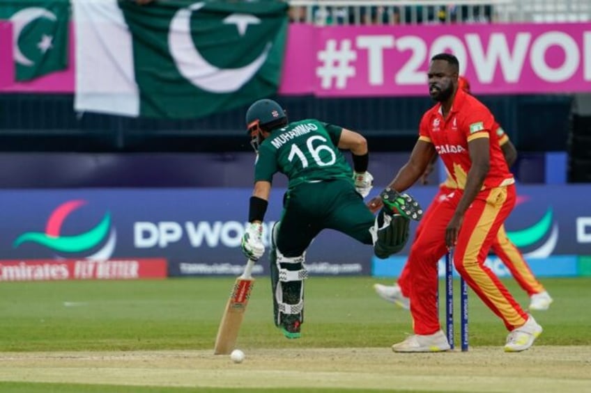 On the run: Pakistan's Mohammad Rizwan makes his ground as Canada's Jeremy Gordon looks on