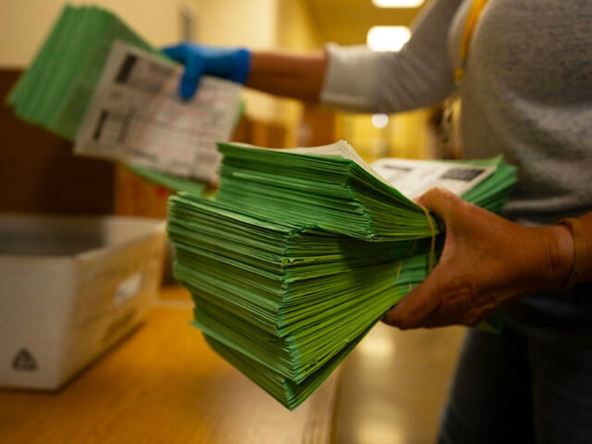 An election official sorts mail ballots at the Maricopa County Tabulation and Election Cen