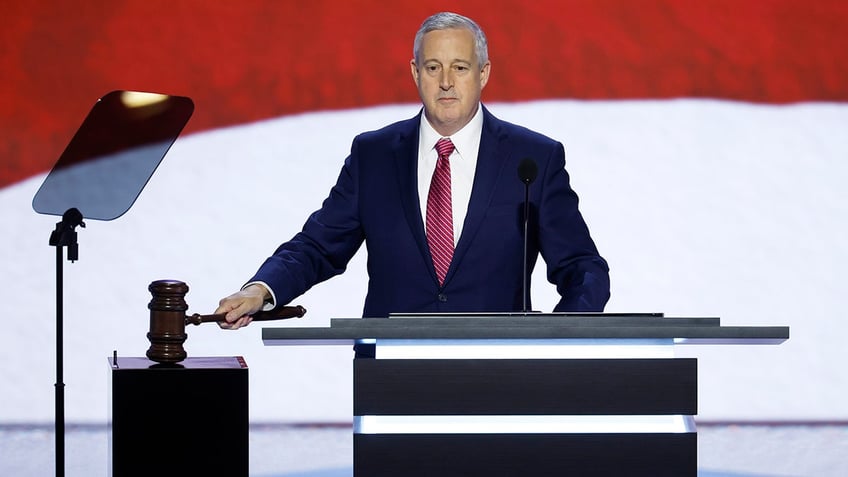 Michael Whatley gavels in and calls the convention to order on the first day of the Republican National Convention