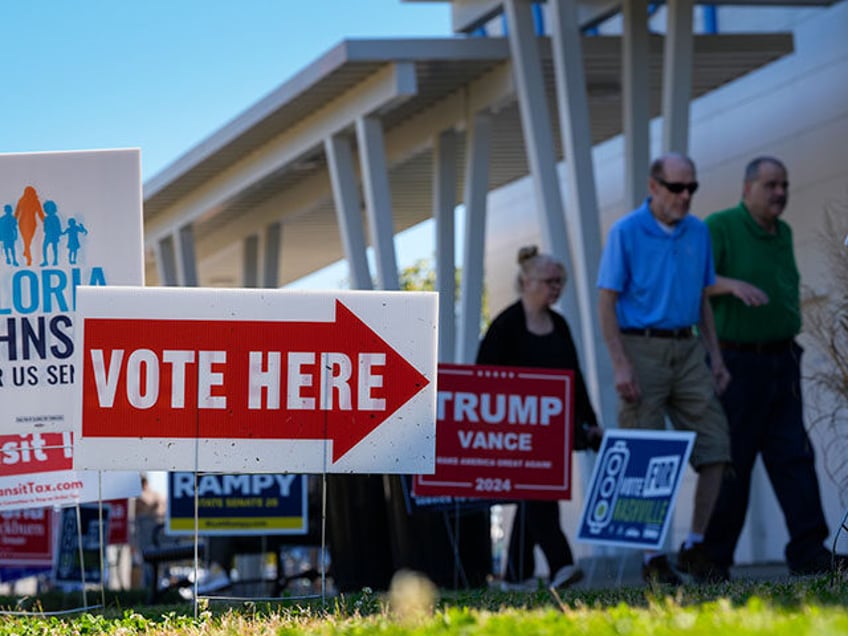 Campaign signs are seen outside an early voting polling place at the Southeast Library, Th