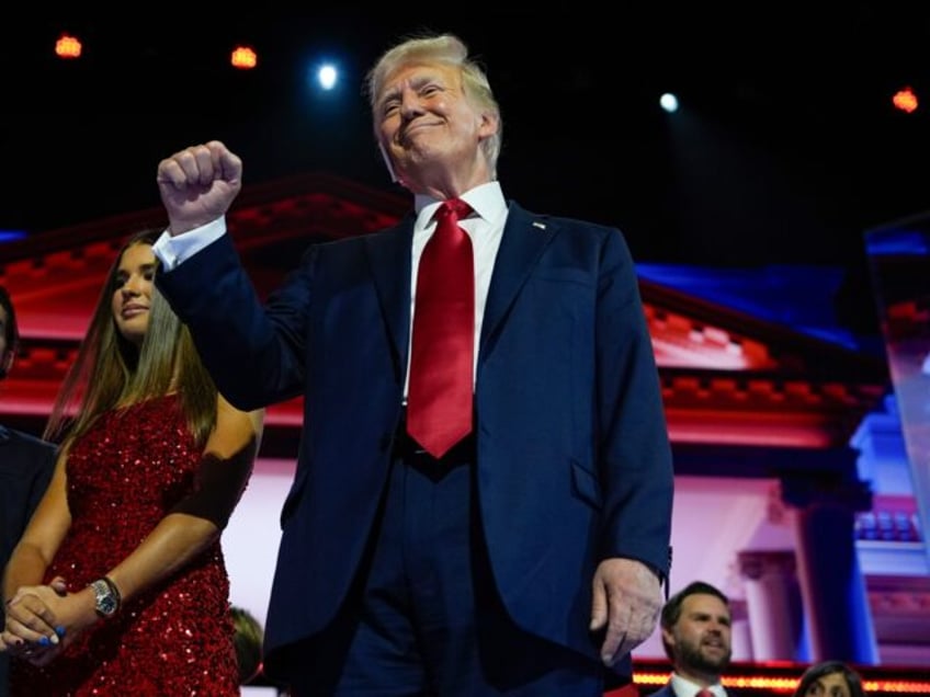 Republican presidential candidate former President Donald Trump stands on stage during the