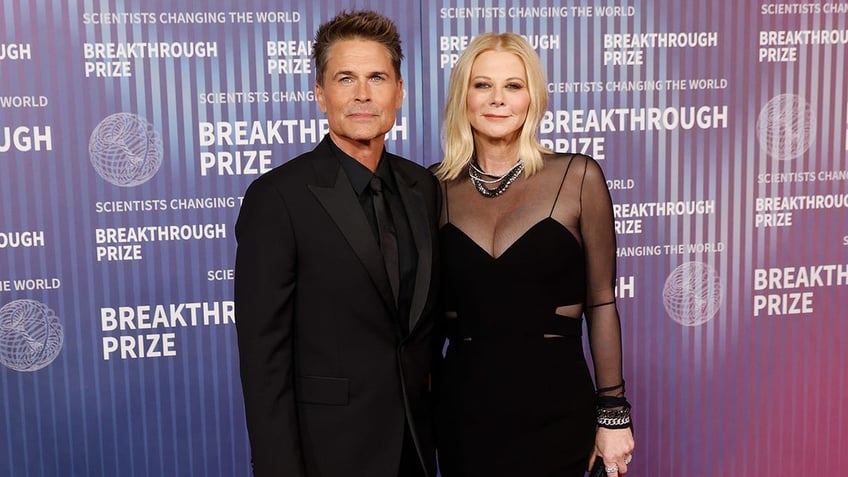 Rob Lowe and Sheryl Berkoff posing together on the red carpet