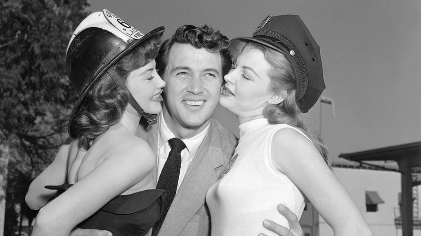 Rock Hudson holding two women