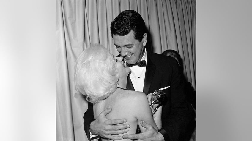 Rock Hudson embracing Marilyn Monroe