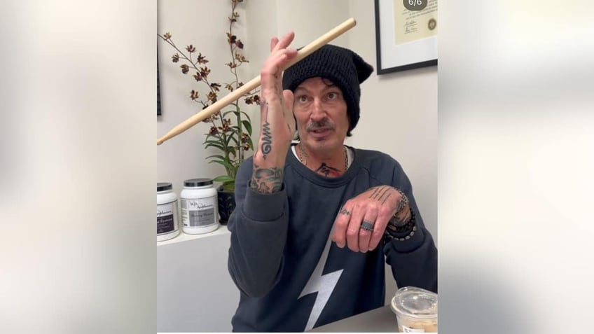 Tommy lee twirling drumsticks