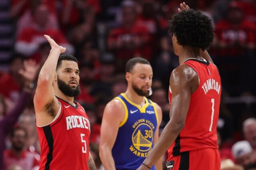 Fred VanVleet and Amen Thompson of the Houston Rockets high five in front of Golden State