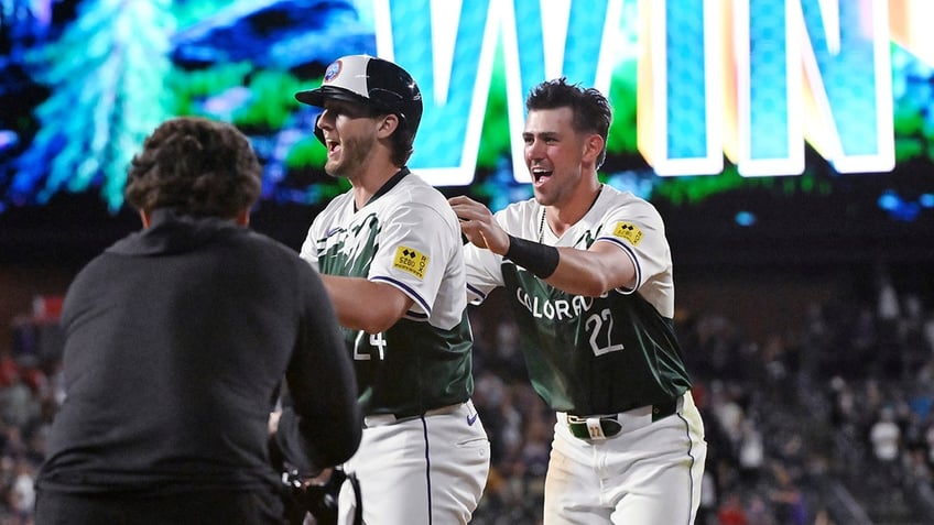 Ryan McMahon and Nolan Jones celebrates