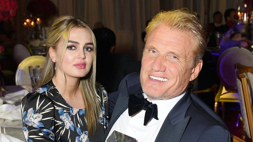 Dolph Lundgren sitting with Emma Krokdal in 2020