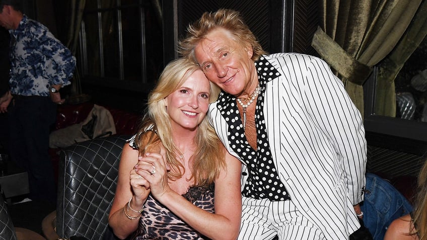 Rod Stewart with his arm around Penny Lancaster