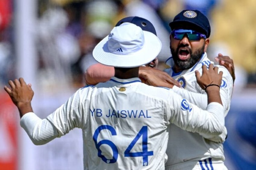 India's captain Rohit Sharma celebrates with teammates during the fourth day of the third