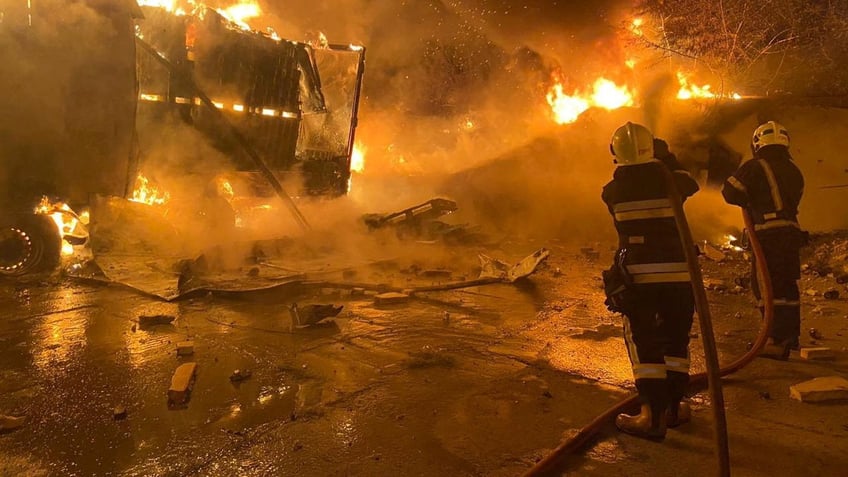 Firefighters extinguish fire in trucks at a site where warehouse facilities were hit during a Russian drone strike, amid Russia's attack on Ukraine, in the village of Murovane, outside of Lviv, Ukraine Sept. 6, 2024.