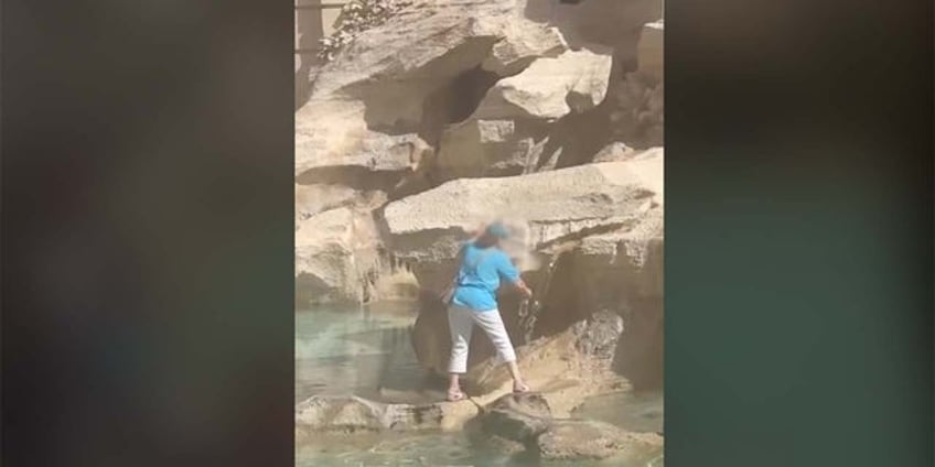 rome tourist stuns onlookers by climbing across historic landmark to fill water bottle