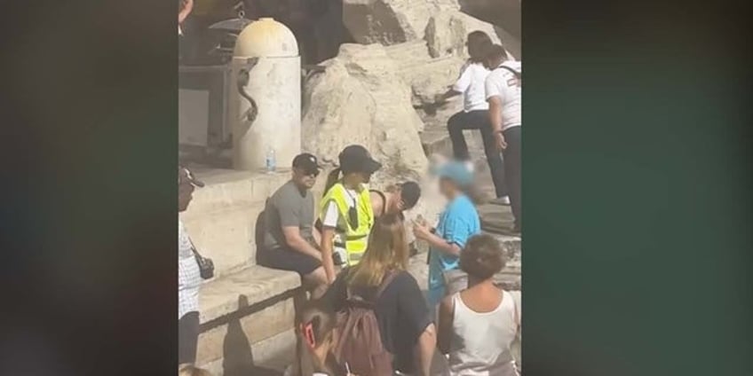 rome tourist stuns onlookers by climbing across historic landmark to fill water bottle