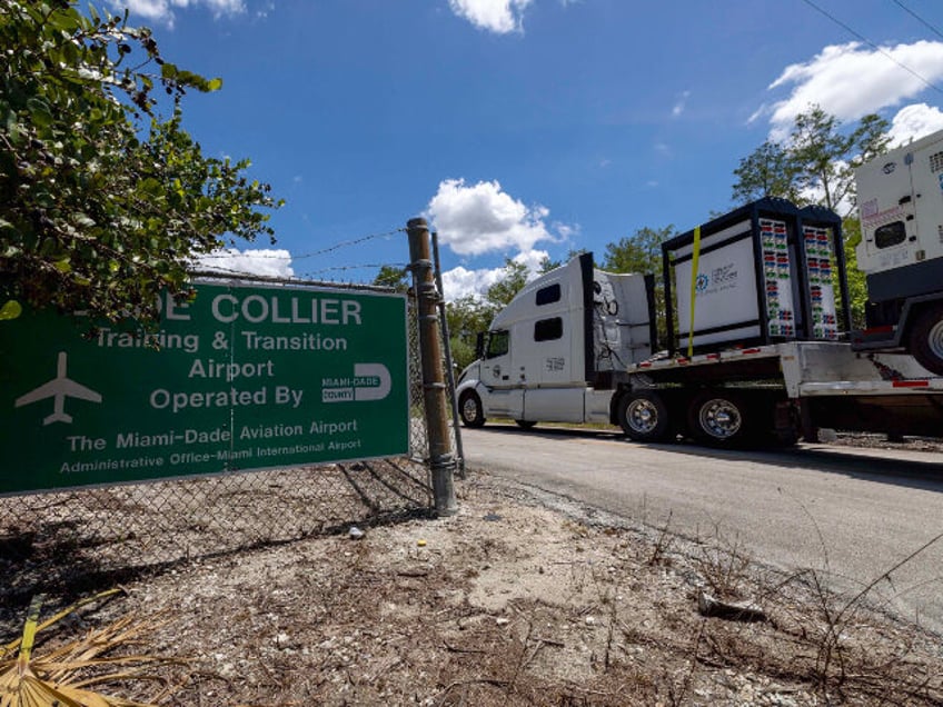 Heavy duty generators are driven into Dade Collier Training and Transition Airport off Tam