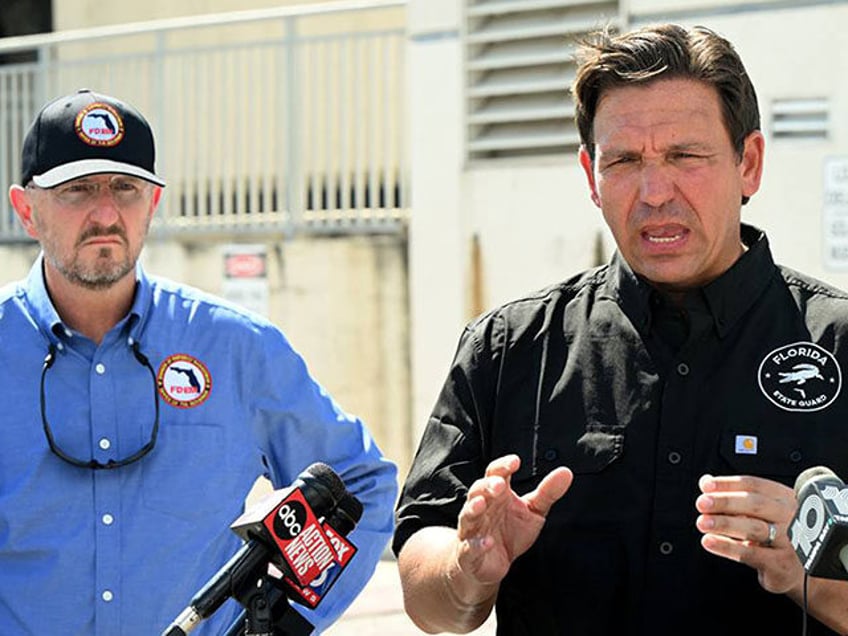 Florida Gov. Ron DeSantis, right, with FDEM Director Kevin Guthrie, left, speaks at a pres