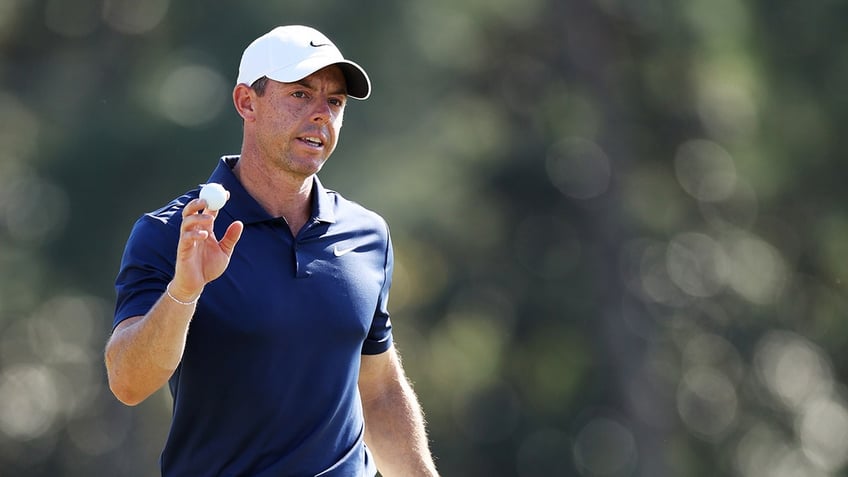 Rory McIlroy waves to the group