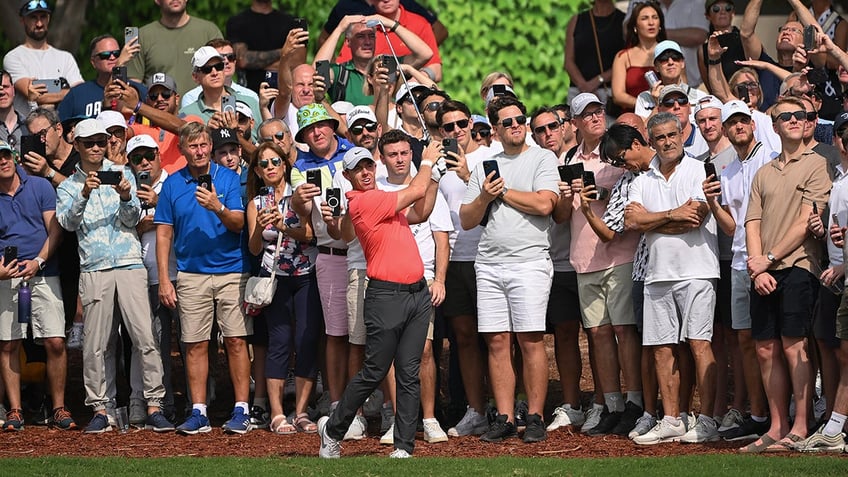 rory mcilroys wild shot at world tour championship lands in fans lap