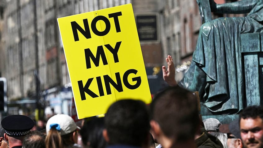 A close-up of a yellow sign that reads "Not my king"