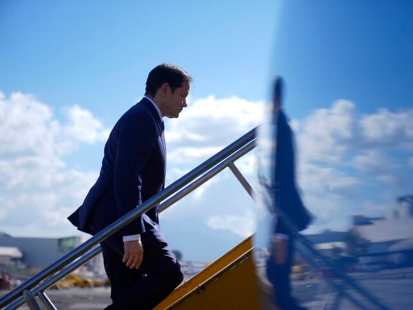 Secretary of State Marco Rubio boards a plane at La Aurora International Airport in Guatem