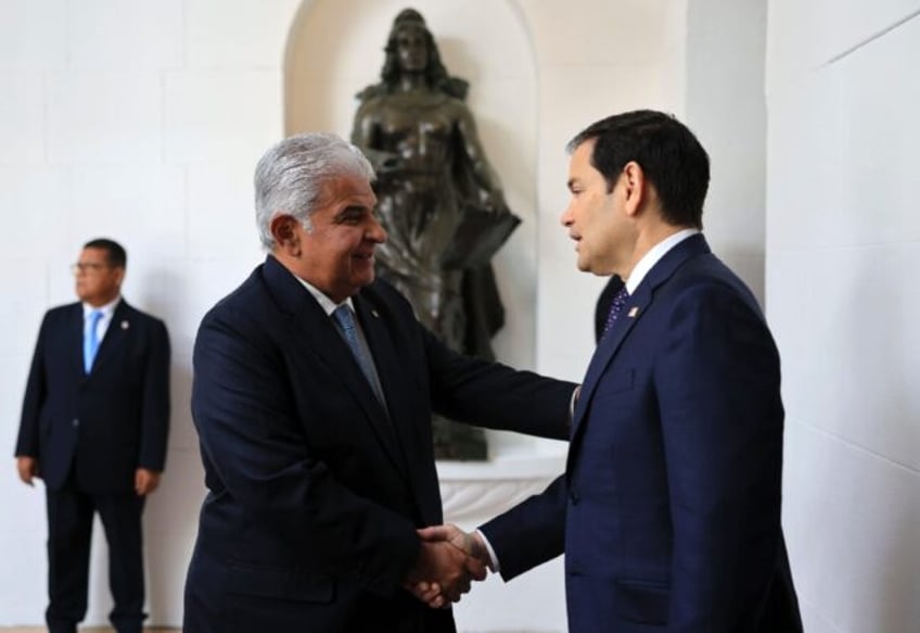 Panama's President Jose Raul Mulino (L) greets US Secretary of State Marco Rubio on arriva