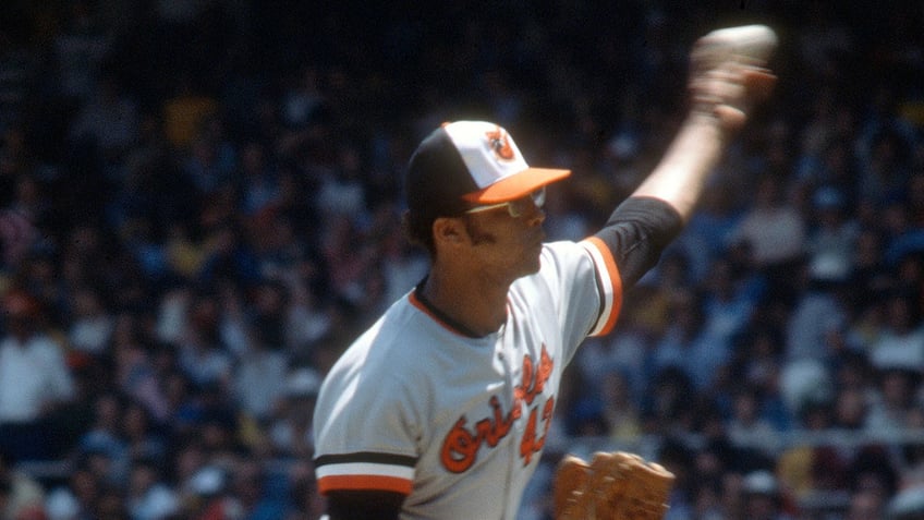 Rudy May throws pitch