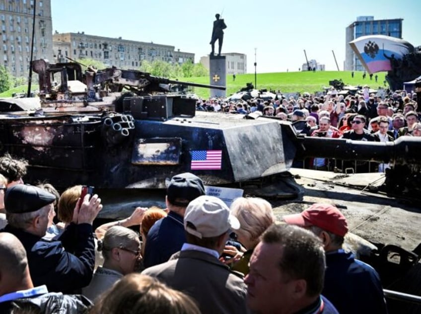 People look at US M12A1 Abrams tank captured by Russian forces in Ukraine, displayed at th