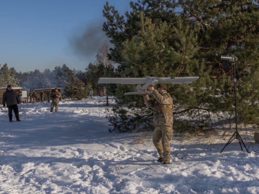 A Ukrainian serviceman prepares to launch a drone during a military training which focuses on fighting sabotage groups, in the Chernihiv region, on December 5, 2023, amid the Russian invasion of Ukraine. (Photo by Roman PILIPEY / AFP) (Photo by ROMAN PILIPEY/AFP via Getty Images)