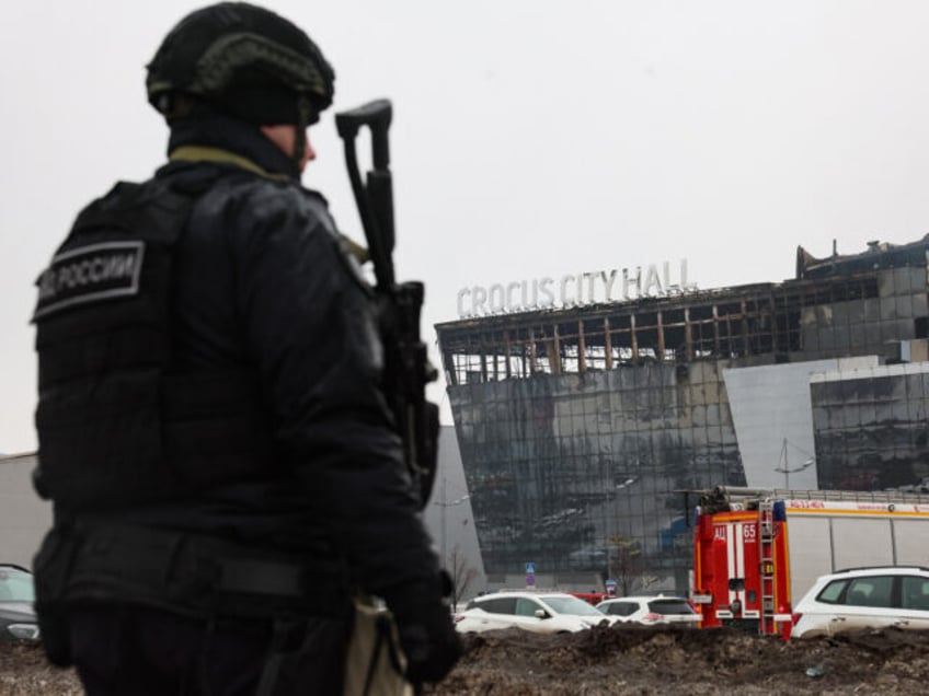 TOPSHOT - A law enforcement officer patrols the scene of the gun attack at the Crocus City